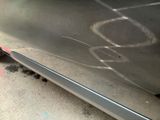 a close up of a car ' s door handle with a sticker on it