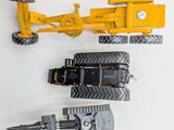 a yellow toy tractor and a black toy tractor