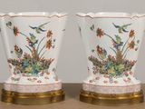 two vases that have birds and flowers on them