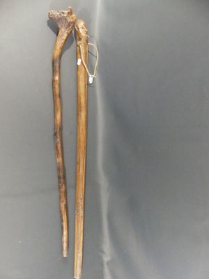 pair of wooden walking sticks on a grey background