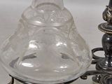 a glass vase sitting on top of a table next to a lamp