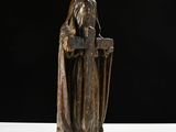 statue of a woman with a bird on her head sitting on a table