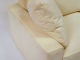 a white couch with pillows on it on a white background