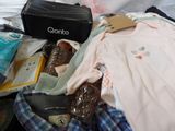 a suitcase full of clothes and other items on a bed