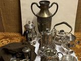 a table with a lot of silver items on it