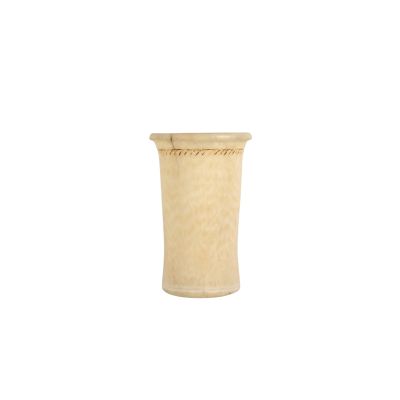 a small vase with a wooden base on a white background