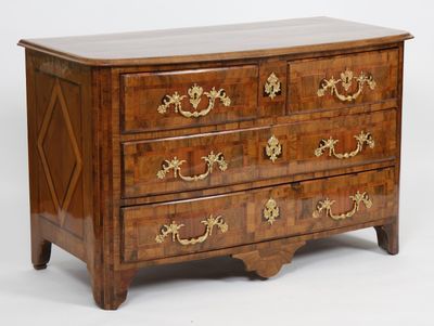 a wooden chest of drawers with gold decorations on it