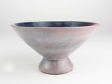 a small bowl that is sitting on a white surface