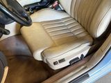 a tan leather seat in the back of a car