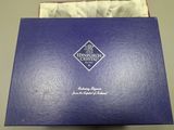 an open blue box with a logo on it sitting on top of a table