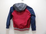 hooded jacket hanging on a hook on a white wall