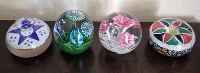 four glass easter eggs sitting on top of a table next to each other