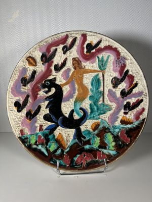 a decorative plate with a woman and a horse on it