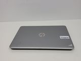 the laptop is sitting on a white table with a sticker on it