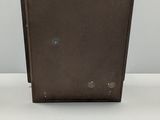 pair of brown leather suitcases on a white surface
