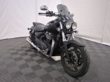a black motorcycle that is parked on a checkered floor