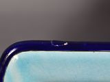 underside of a blue and white vase with a hole in the middle