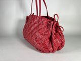 an image of a red purse on a white surface