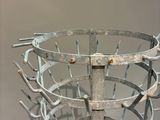 a metal basket that has a bunch of forks inside of it