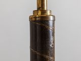 a close up of a black and gold umbrella on a white background