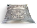 a silver bell with a cross on it on a white background