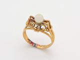 an image of a gold ring with a pearl in the center