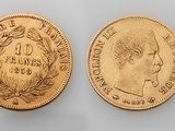a gold coin with a woman ' s face and laurels on it