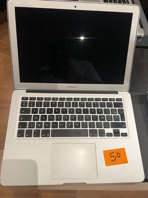 a laptop computer sitting on a table with a price tag on it