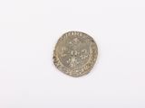 a close up of a silver coin on a white surface