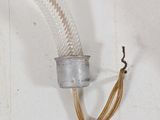a hose attached to a wall with a wire attached to it