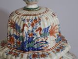 a white vase with a blue and red design on it