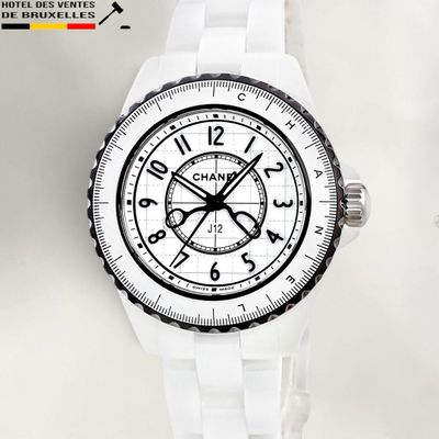 a close up of a watch on a white surface