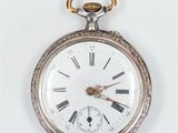 a silver pocket watch with roman numerals on it