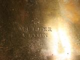 a close up of a metal plate with a name engraved on it