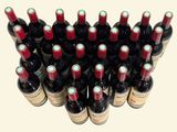 many bottles of wine that are stacked on top of each other