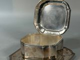 a silver box that is sitting on a silver tray