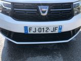 a close up of a white car with a number plate on it