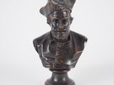 statue of a bust of a man with a hat on his head