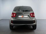 the rear end of a silver car in a white room