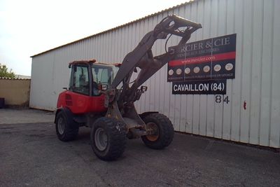 a tractor that is parked in front of a building