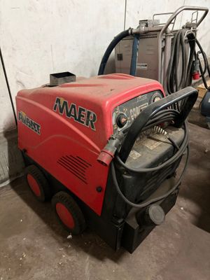 a red machine that is sitting in the garage