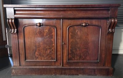 a wooden cabinet that has two doors on it