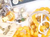 a bunch of jewelry on a table next to a book