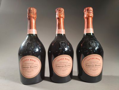 three bottles of champagne sitting next to each other on a table