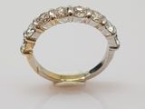 a white and yellow gold ring with five diamonds