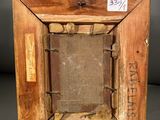 an old wooden picture frame with a cross on top of it