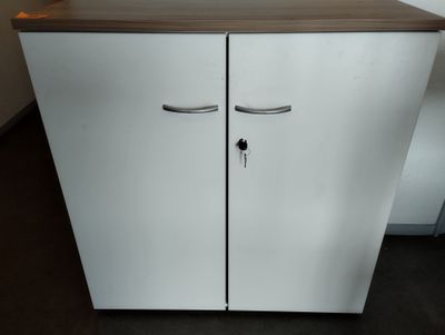 a white cabinet with two doors and a brown counter top