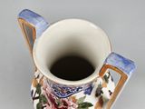 a cup with a handle that has a flower design on it