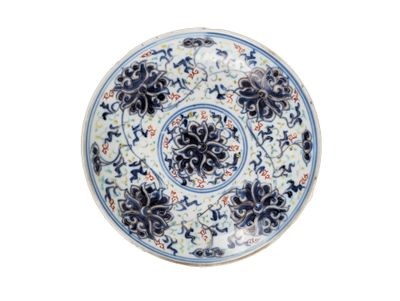 a blue and white plate with a floral design on it