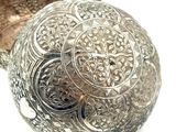 a silver bowl that has a decorative design on it